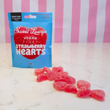 Load image into Gallery viewer, Vegan fizzy strawberry heart sweets by sweet lounge next to packet
