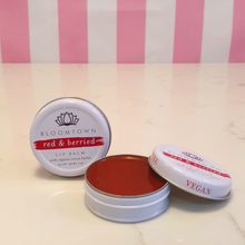 Load image into Gallery viewer, Vegan Red lipbalm in a small white tin labeled Bloomtown red & berried lipbalm with organic cocoa butter