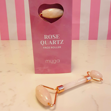 Load image into Gallery viewer, Rose Quartz Face Roller by Myga in a box and lying on the marble