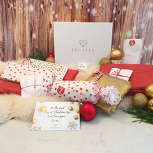 Load image into Gallery viewer, Gift box and 12 vegan xmas gifts wrapped in Christmas themed tissue
