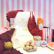 Load image into Gallery viewer, Gift box and 12 advent gifts for women including camisole set, nighty, robe, chocolate truffles, candle, bath salts, prosecco sweets, hot chocolate, face roller, earrings, make-up bag and lipbalm

