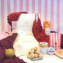 Load image into Gallery viewer, Gift box and 12 vegan Christmas gifts for women including camisole set, nighty, robe, chocolate truffles, candle, bath salts, prosecco sweets, hot chocolate, face roller, earrings, make-up bag and lipbalm
