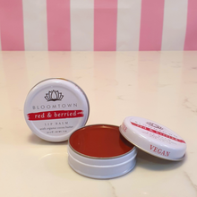 Load image into Gallery viewer, Vegan Red lipbalm in a small white tin labeled Bloomtown red &amp; berried lipbalm with organic cocoa butter
