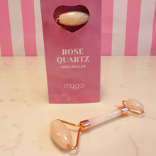 Load image into Gallery viewer, Rose Quartz Face Roller by Myga in a box and lying on the marble

